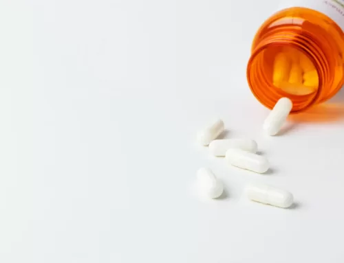 Prescription painkillers spilling from an orange bottle, symbolizing the link to fentanyl addiction and the importance of rehabilitation services.